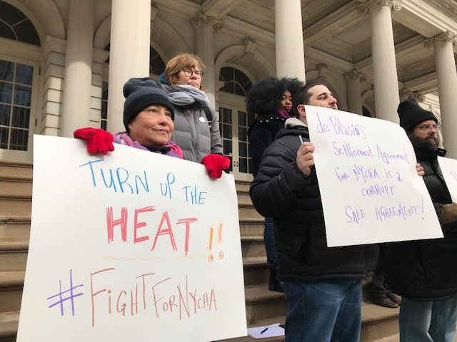 Activists attend a protest on Sunday to protest NYCHA's privatization plan.
