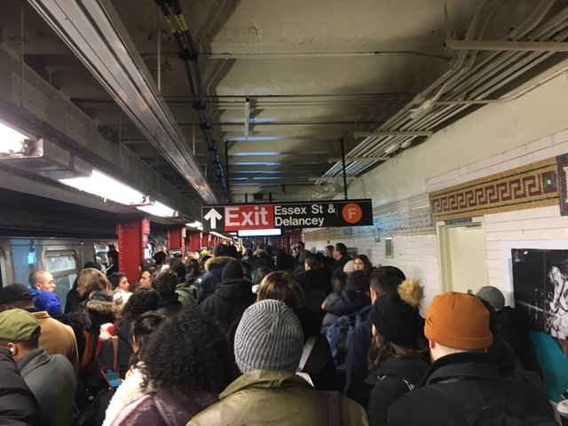 A crowded M train platform at Delancey/Essex after a person was truck by a train at Herald Square this morning.