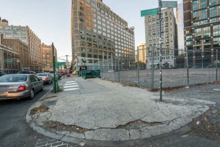 A broken curb cut on a street corner in NYC.