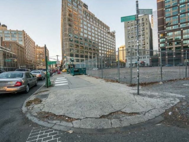 A broken curb cut on a street corner in NYC.