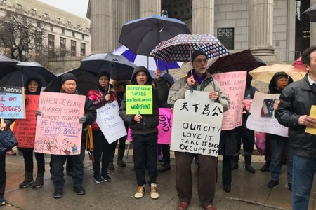Protesters show up for a press conference on Friday, March 22, 2019, announcing a lawsuit over the Two Bridges development.