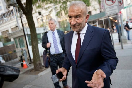 Alain Kaloyeros, foreground, leaves federal court in New York.