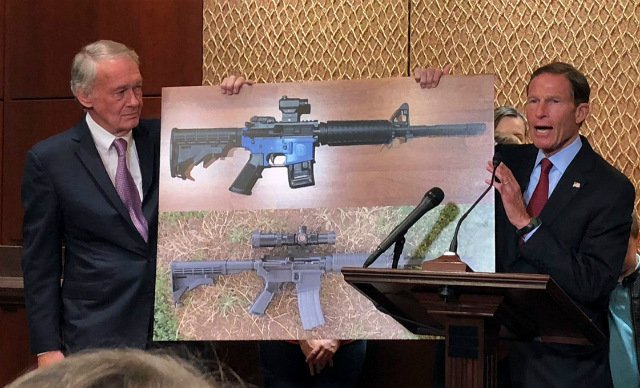 Sen. Edward Markey and Sen. Richard Blumenthal display a photo of a plastic gun, on Capitol Hill in Washington
