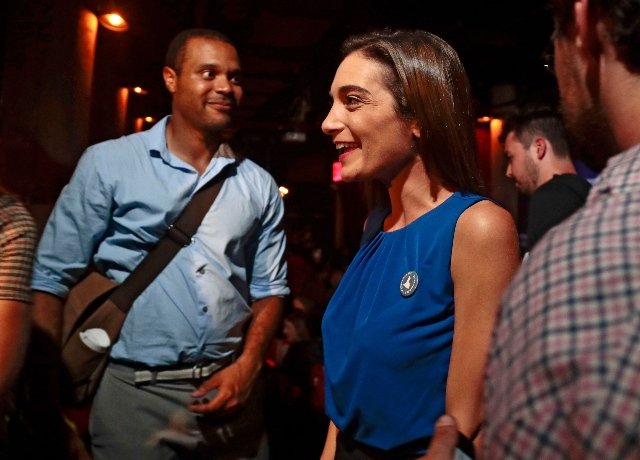 Julia Salazar, right, talks with supporters after winning the Democratic primary over Martin Dilan in New York's 18th State Senate district race.