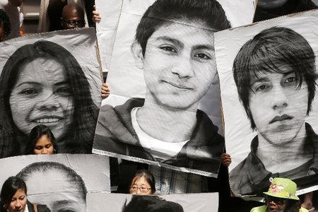 Supporters of the New York DREAM Act hold photos of undocumented students who are not eligible for college tuition assistance during a rally at the Capitol in Albany in 2013.