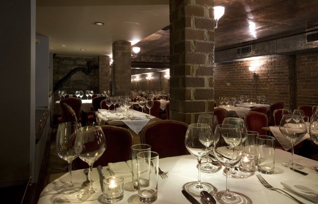 111209barhenry.jpg Sometimes there's nothing more comforting in the winter than heading into the dark indoors and warming yourself up with some good wine. Bar Henry definitely evokes the feeling of a dark wine cellar, with brick walls and dark wood ceilings creating a cozy atmosphere. The bar embraces a "ready to drink" policy with their wines, choosing them at the peak of their flavor, including some reserves at under $100 a bottle. They're offering a few specials to encourage the accessibility of wine, including a special of buying half of any of the 100 bottles on the market list for half the price of the bottle. The remaining half of the bottle will be available to all customers by the glass. Bar Henry also offers some cool cocktails, such as the Captain Berelsky's Skull and Bones, a mix of lavored rum and secret ingredients (Berelsky being a Caribbean pirate and a direct ancestor of Winston Kulok, owner of Bar Henry.) Food is standard bistro fare, with dry aged steak and roast chicken, and rest assured there will be wines to match.90 W Houston St, (646) 448-4559