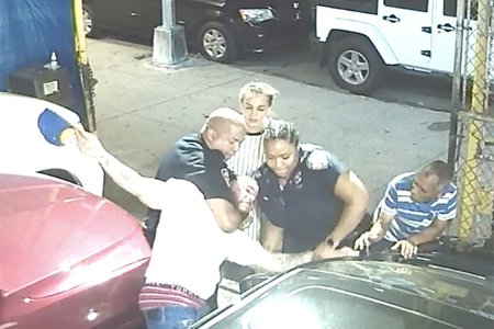Still showing Medina being restrained by police