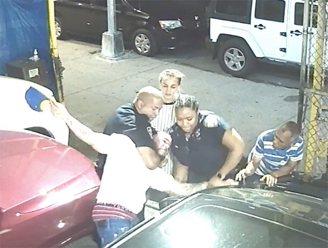 Still showing Medina being restrained by police