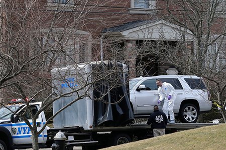 Crime scene investigators look at an SUV outside of Frank Cali's home on Staten Island