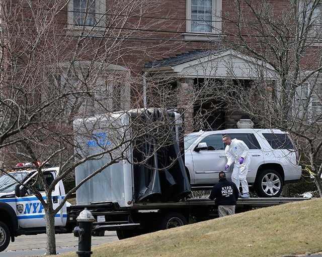 Crime scene investigators look at an SUV outside of Frank Cali's home on Staten Island