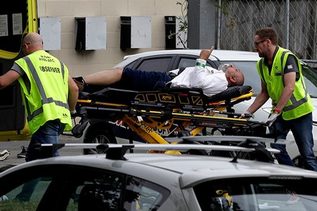 Ambulance staff take a man from outside a mosque in central Christchurch, New Zealand