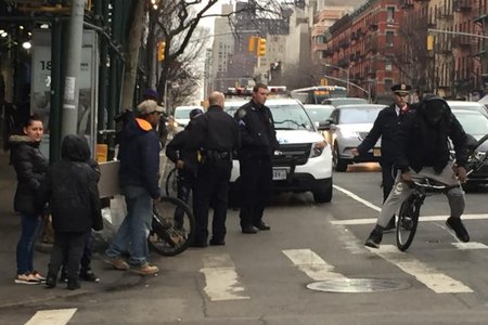 An NYPD officer shoves a bicyclist off his bike to give him a ticket, according to a witness.