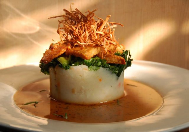 54cinnsnail1011.jpg Apple cider glazed tempeh with rosemary root vegetable puree, matchstick fried parsnips, and marinated kale