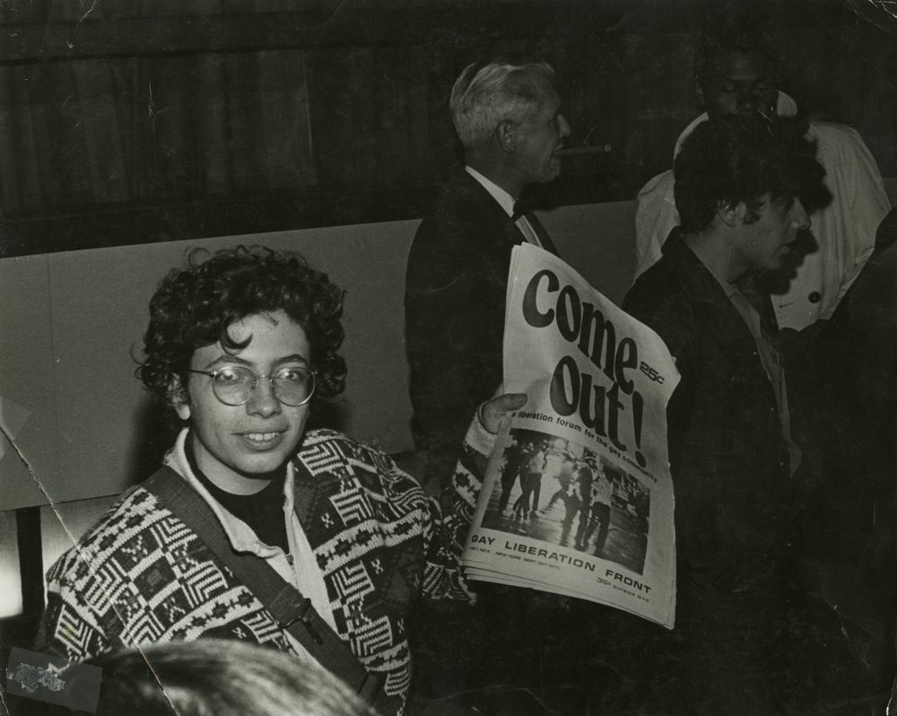 6452095a5copy-of-tl083-jpg.jpeg Martha Shelley sells Gay Liberation Front paper during Weinstein Hall demonstration, 1970. Photo by Diana Davies.<br/>