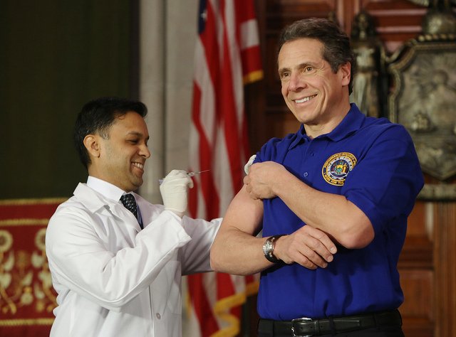 Governor Cuomo receives a flu shot from Health Commissioner, Dr. Nirav Shah, to enourage all New Yorkers to guard against a bad flu season, in 2013