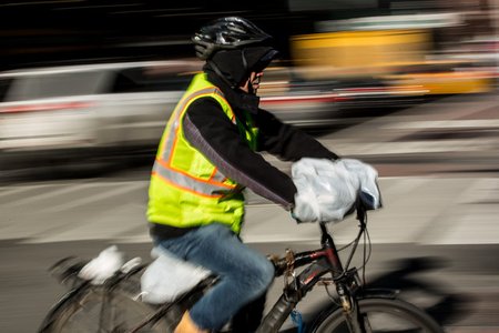 Chen Qixiong, 56, delivering food on his throttle-controlled e-bike in Midtown this past winter. "For us delivery guys, we don’t make that much money," Chen told Gothamist. "To fine us $500, that’s a whole week’s worth of money gone.”