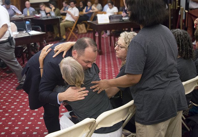 City Council Speaker Corey Johnson hugs a safe streets advocate on Tuesday during an emergency Transportation Committee hearing on speed cameras.