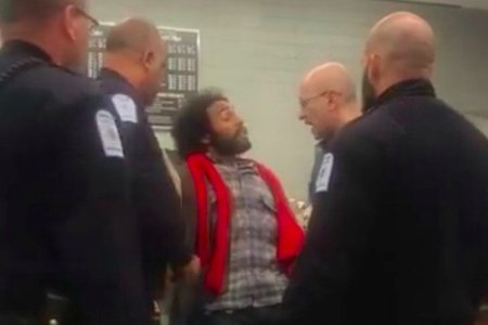 Alexander McNab surrounded by several campus security officers
