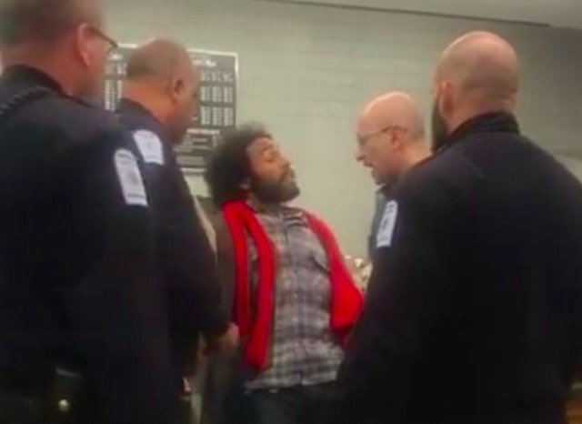 Alexander McNab surrounded by several campus security officers