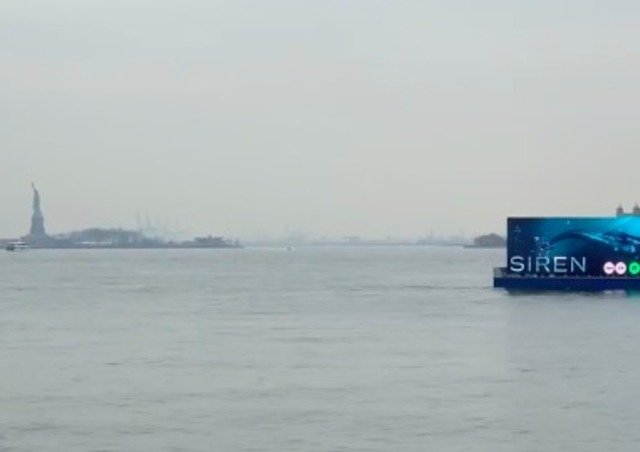 The barge passing in front of the Statue of Liberty earlier this month