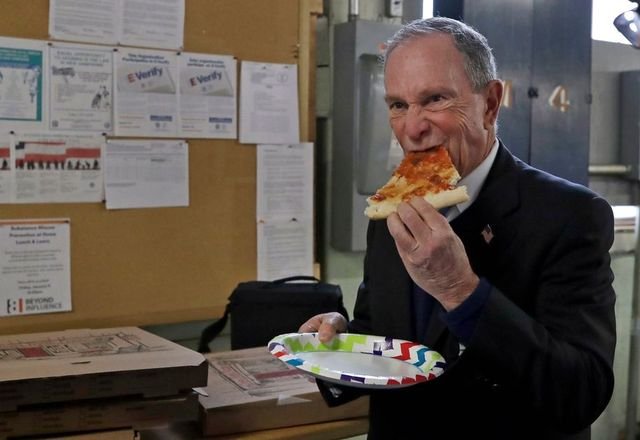 Michael Bloomberg wolfs down a slice of peasant bread