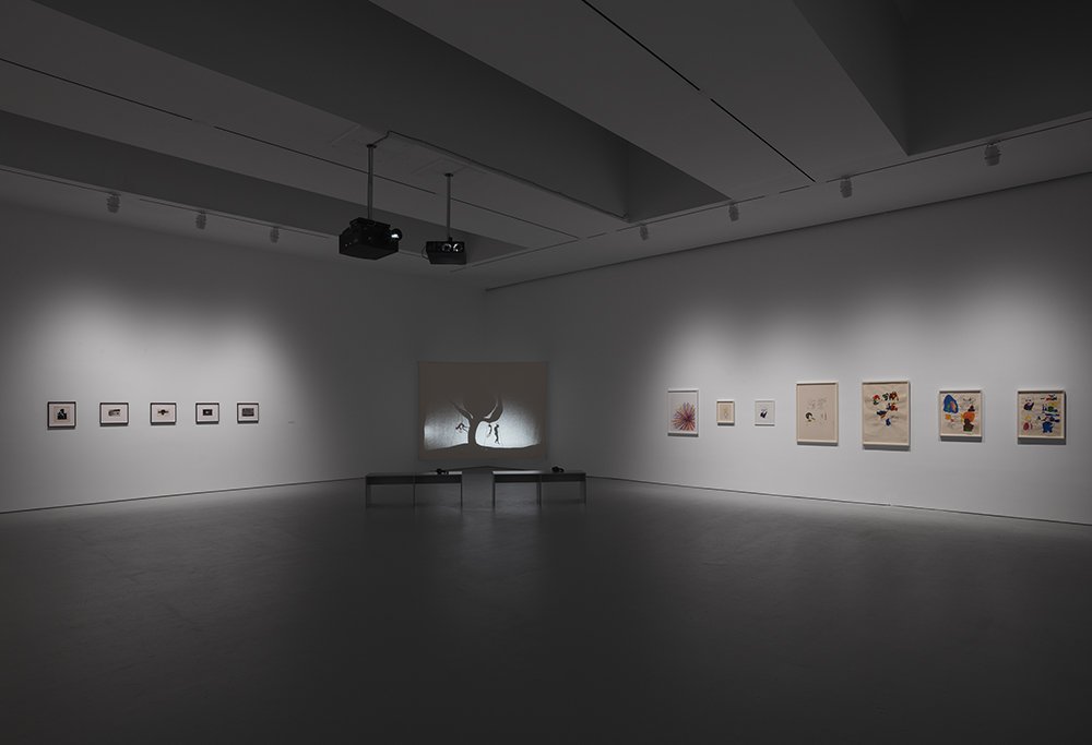 d92b12d17hiltonbaldwindz19show2019_install_36-jpg.jpeg Photographs by Alvin Baltrop (left) and prints by Glenn Ligon (right) flank Kara Walker's video, "8 Possible Beginnings or: The Creation of African-America, a Moving Picture"<br>(Courtesy of David Zwirner)