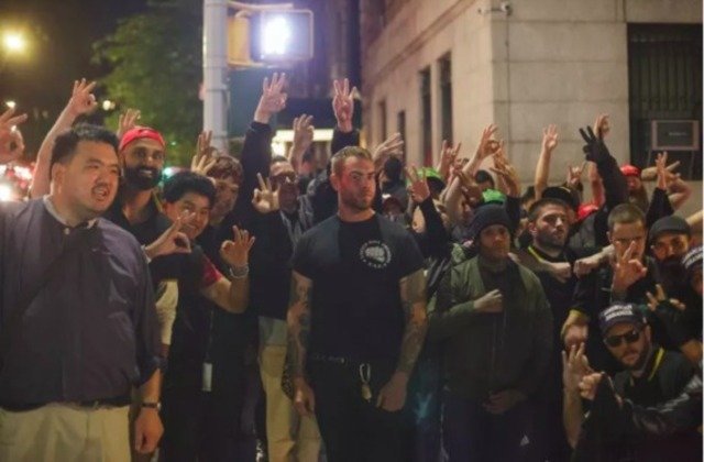 Proud Boys posing for a group photo in the aftermath of their brawl with protesters