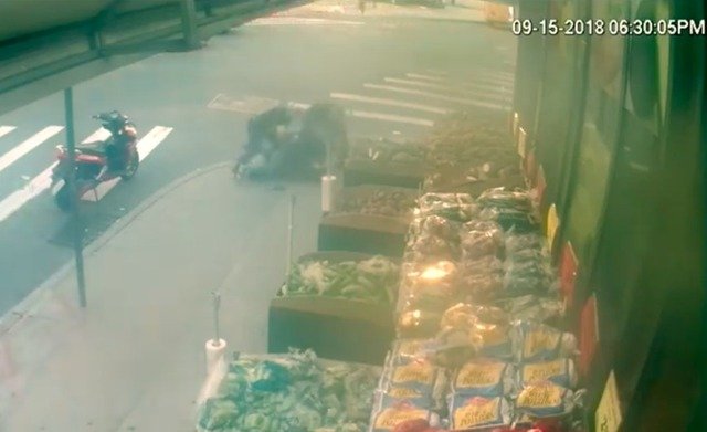 A still of the surveillance footage showing three police officers on top of Christopher Parham