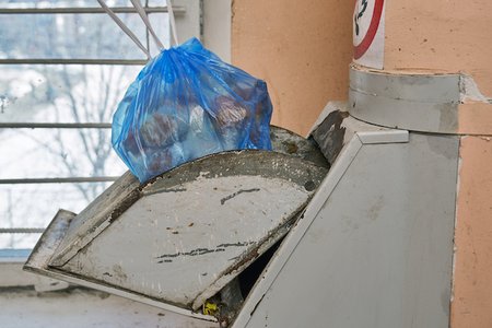 Trash chute is for trash, not doggos.